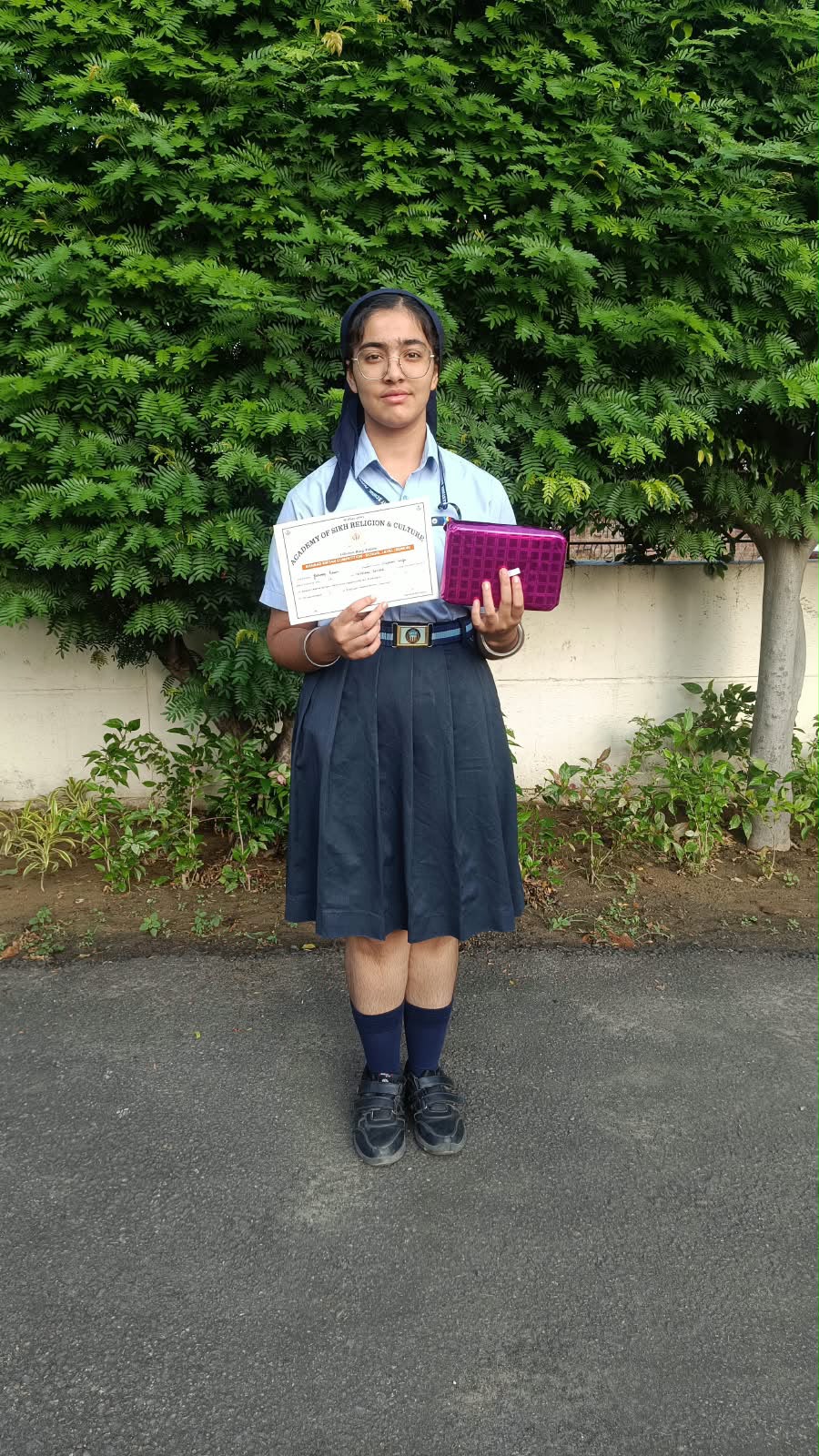 Jotroop Kaur of Grade IX receiving recognition for her Shabad Gayan achievement